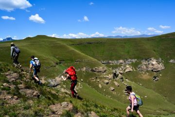 Hikers ascending rocky mountain path