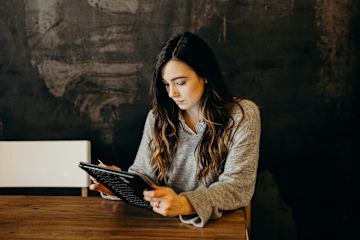 Woman browsing tablet at desk